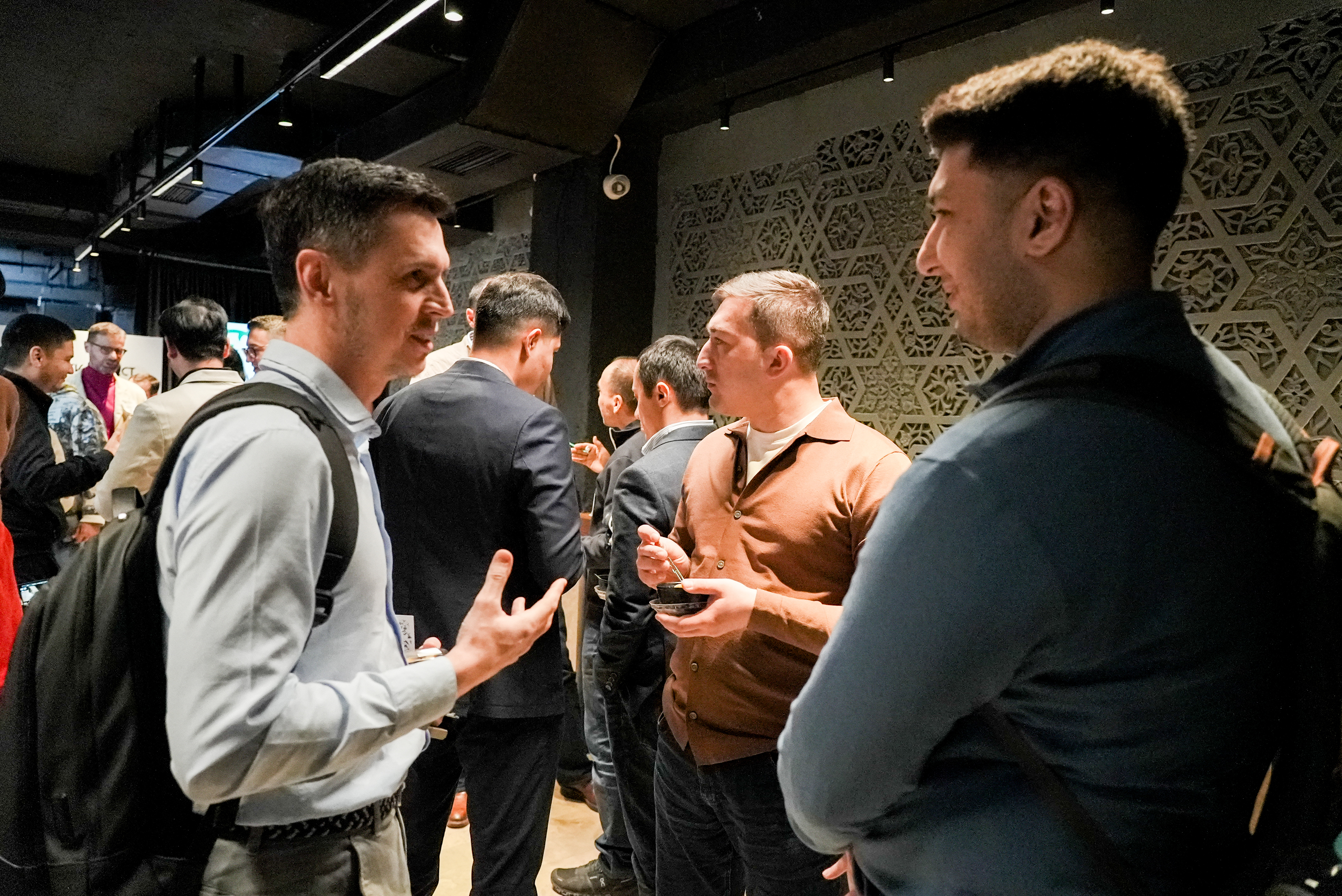 Large crowd networking and conversing at the event venue